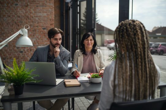 rear-view-of-young-woman-having-job-interview-in-office-business-and-career-concept.jpg